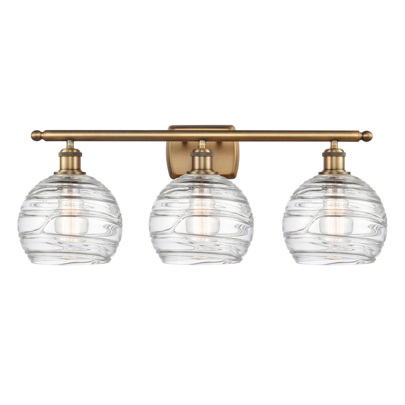 Deco Swirl Bath Vanity Light shown in the Brushed Brass finish with a Clear shade