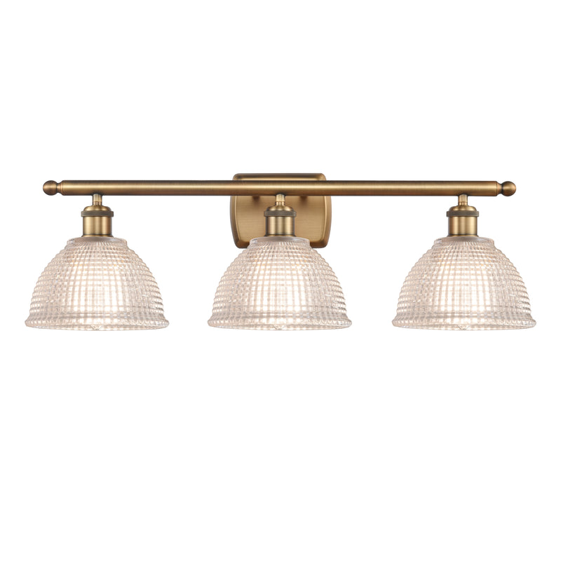 Arietta Bath Vanity Light shown in the Brushed Brass finish with a Clear shade