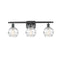 Deco Swirl Bath Vanity Light shown in the Matte Black finish with a Clear shade