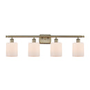 Cobbleskill Bath Vanity Light shown in the Antique Brass finish with a Matte White shade