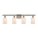 Hadley Bath Vanity Light shown in the Antique Brass finish with a Matte White shade