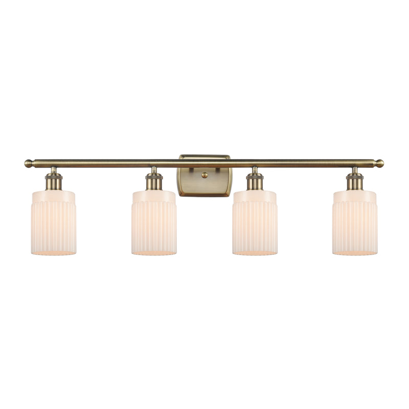 Hadley Bath Vanity Light shown in the Antique Brass finish with a Matte White shade