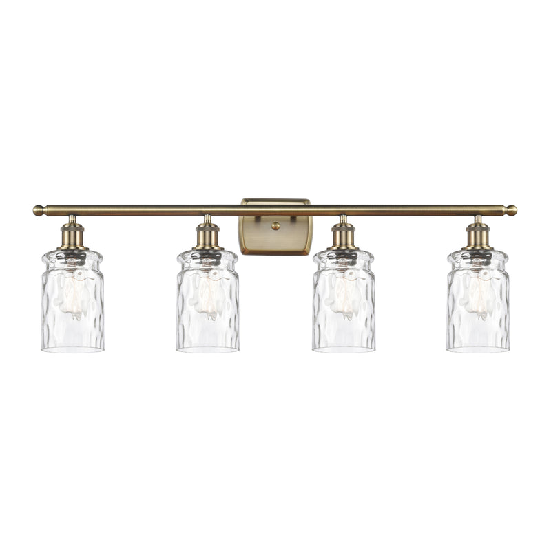 Candor Bath Vanity Light shown in the Antique Brass finish with a Clear Waterglass shade