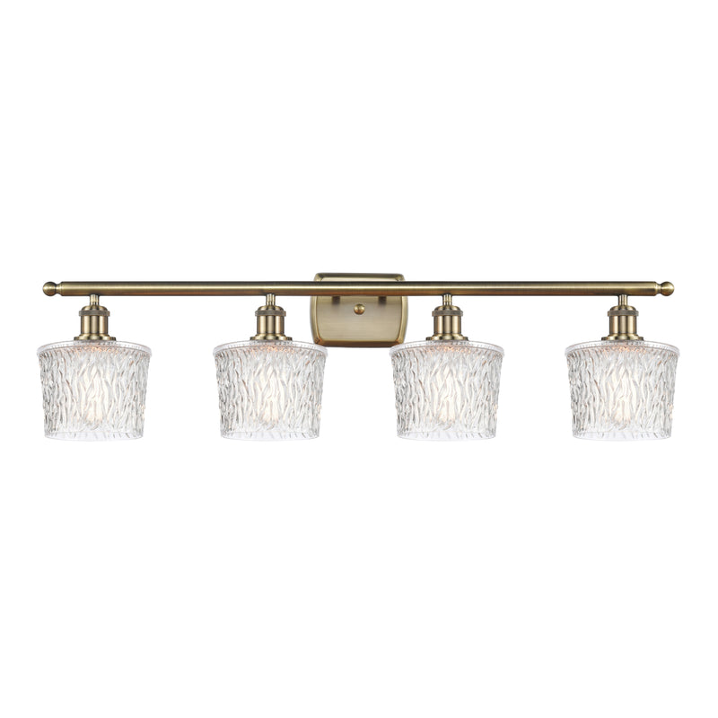 Niagra Bath Vanity Light shown in the Antique Brass finish with a Clear shade