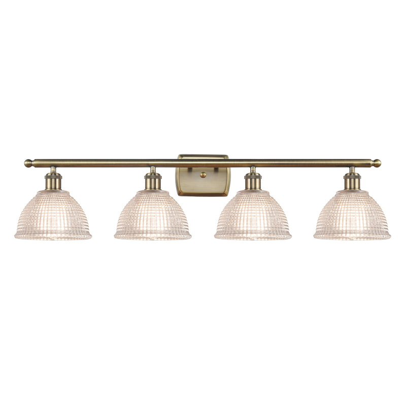 Arietta Bath Vanity Light shown in the Antique Brass finish with a Clear shade