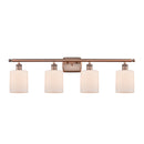 Cobbleskill Bath Vanity Light shown in the Antique Copper finish with a Matte White shade