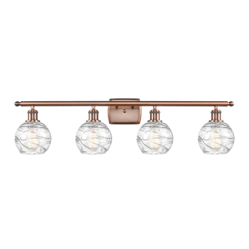 Deco Swirl Bath Vanity Light shown in the Antique Copper finish with a Clear shade