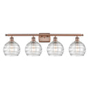 Deco Swirl Bath Vanity Light shown in the Antique Copper finish with a Clear shade