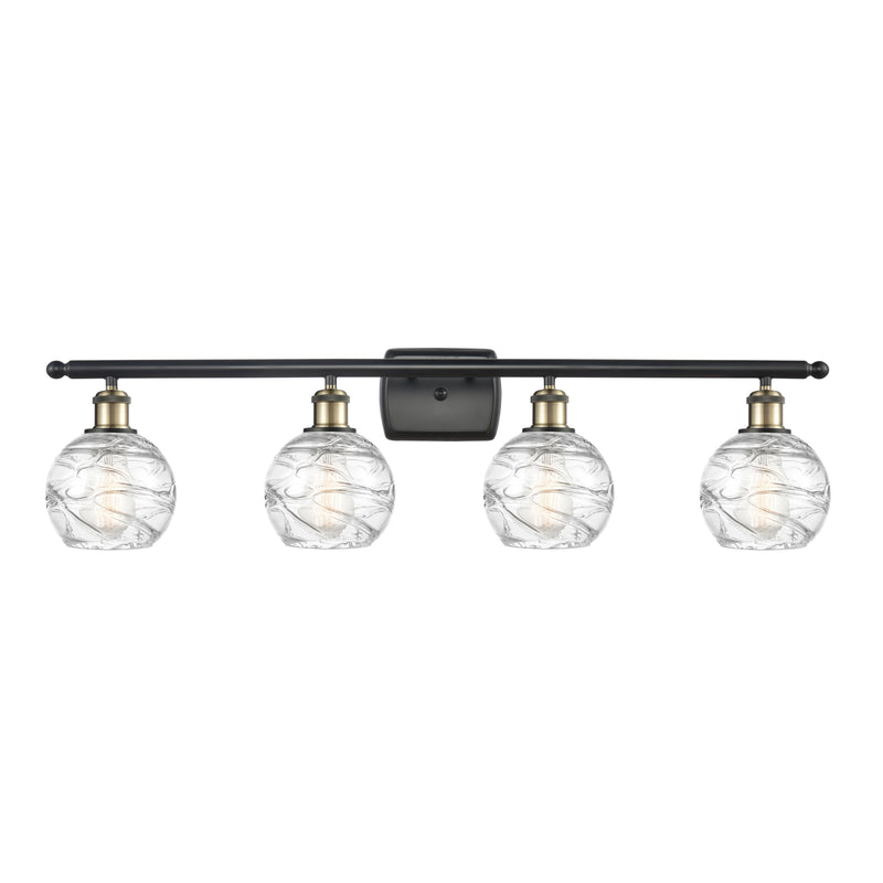 Deco Swirl Bath Vanity Light shown in the Black Antique Brass finish with a Clear shade