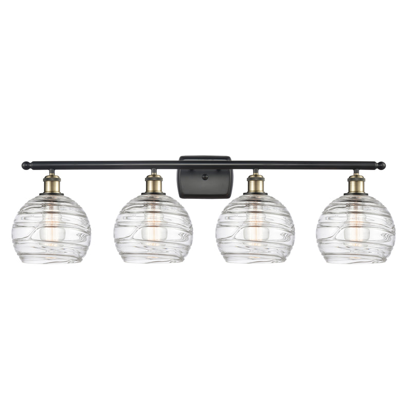 Deco Swirl Bath Vanity Light shown in the Black Antique Brass finish with a Clear shade