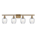 Salina Bath Vanity Light shown in the Brushed Brass finish with a Clear Spiral Fluted shade