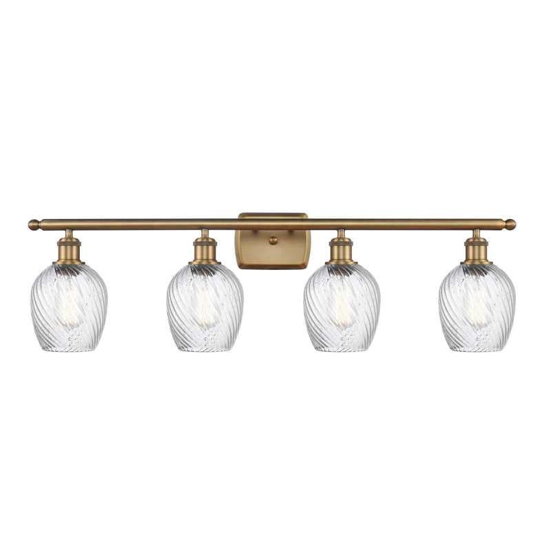 Salina Bath Vanity Light shown in the Brushed Brass finish with a Clear Spiral Fluted shade