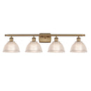 Arietta Bath Vanity Light shown in the Brushed Brass finish with a Clear shade