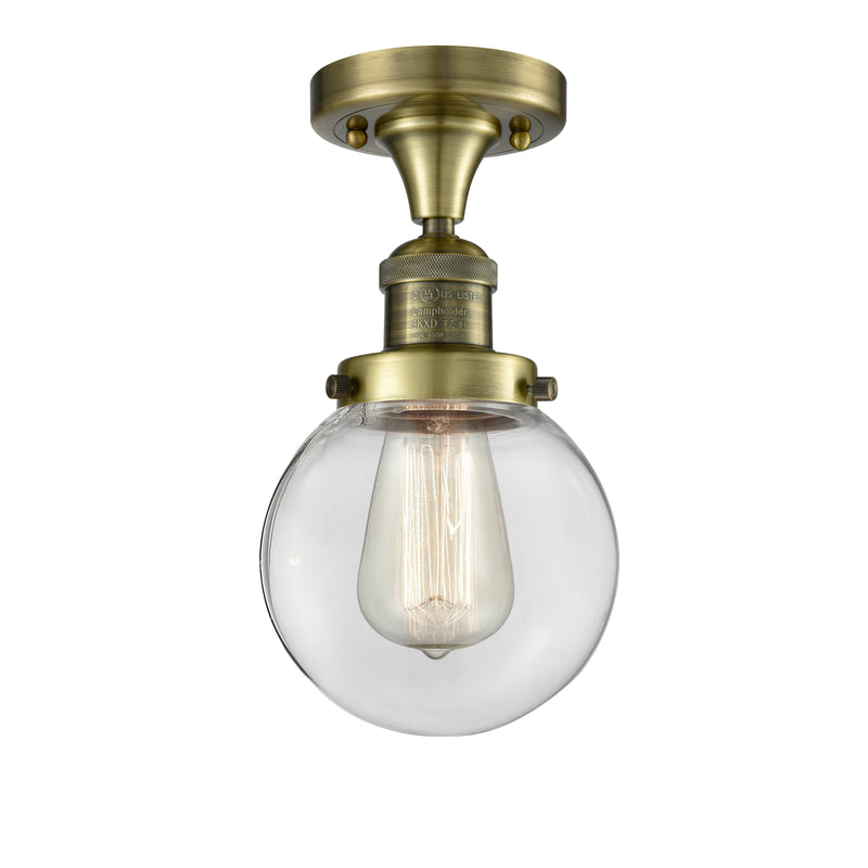 Beacon Semi-Flush Mount shown in the Antique Brass finish with a Clear shade