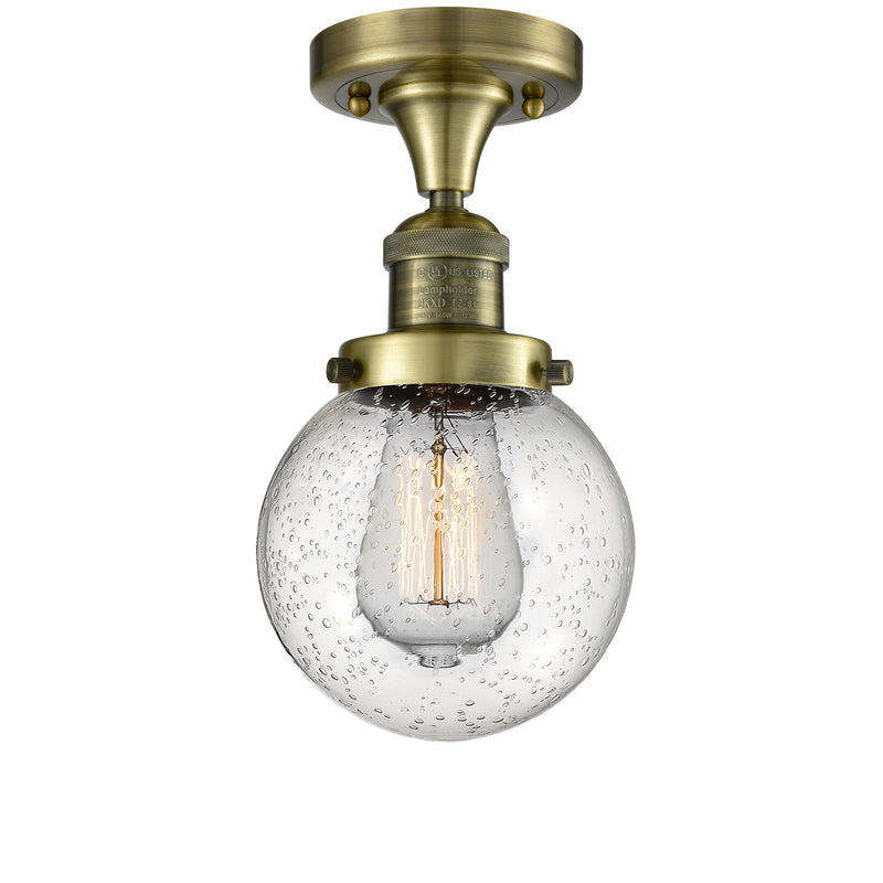 Beacon Semi-Flush Mount shown in the Antique Brass finish with a Seedy shade