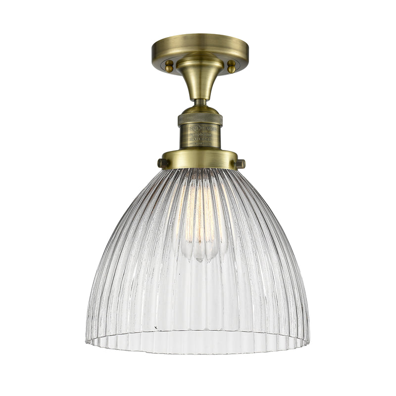 Seneca Falls Semi-Flush Mount shown in the Antique Brass finish with a Clear Halophane shade