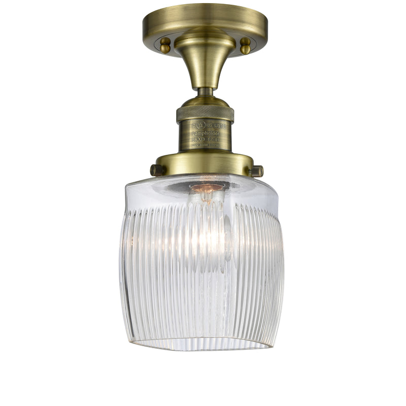 Colton Semi-Flush Mount shown in the Antique Brass finish with a Clear Halophane shade