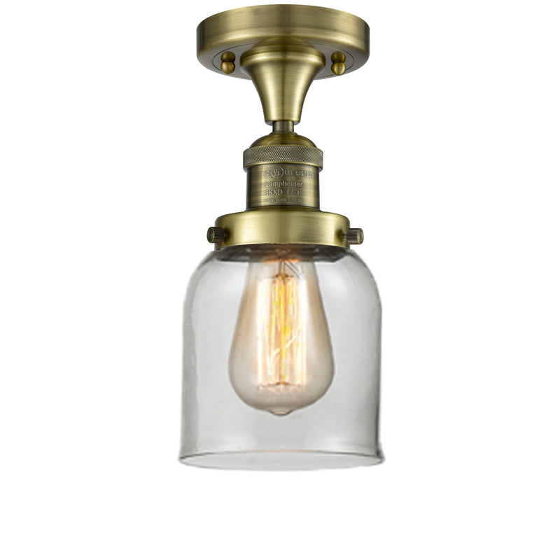 Bell Semi-Flush Mount shown in the Antique Brass finish with a Clear shade