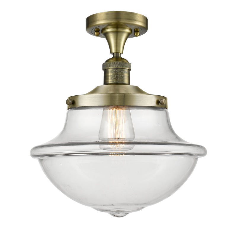 Oxford Semi-Flush Mount shown in the Antique Brass finish with a Clear shade