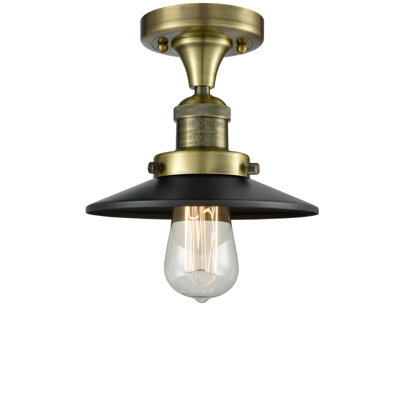 Railroad Semi-Flush Mount shown in the Antique Brass finish with a Matte Black shade