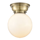 Beacon Flush Mount shown in the Antique Brass finish with a Matte White shade