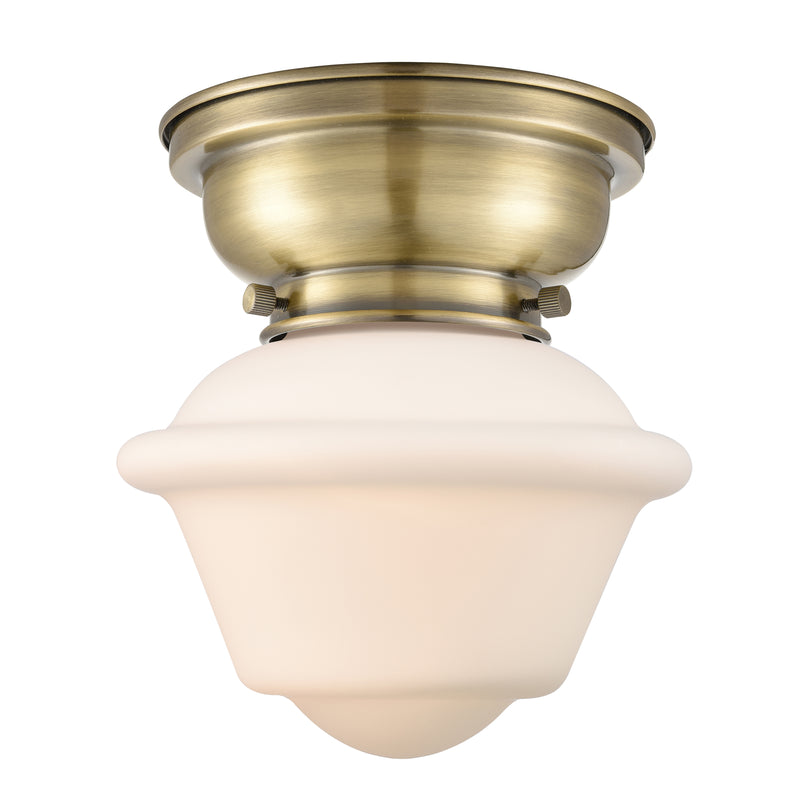 Oxford Flush Mount shown in the Antique Brass finish with a Matte White shade