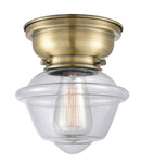 Oxford Flush Mount shown in the Antique Brass finish with a Clear shade