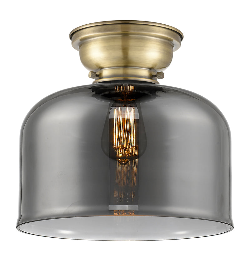 Bell Flush Mount shown in the Antique Brass finish with a Plated Smoke shade