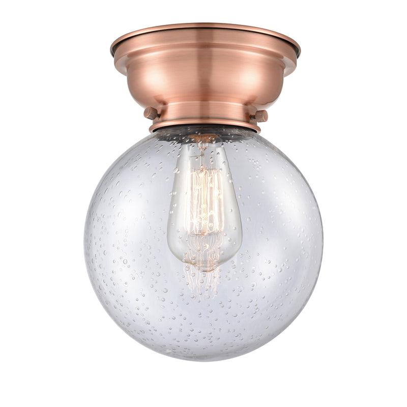 Beacon Flush Mount shown in the Antique Copper finish with a Seedy shade