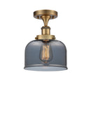 Bell Semi-Flush Mount shown in the Brushed Brass finish with a Plated Smoke shade