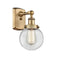 Beacon Sconce shown in the Brushed Brass finish with a Clear shade