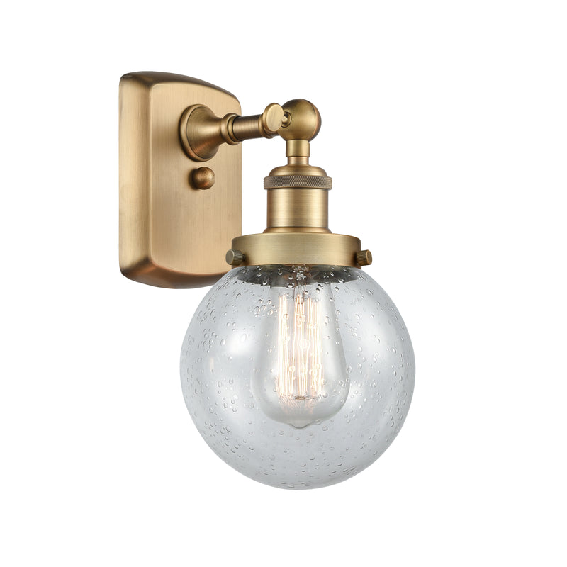 Beacon Sconce shown in the Brushed Brass finish with a Seedy shade