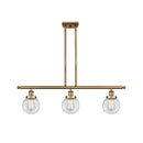 Beacon Island Light shown in the Brushed Brass finish with a Clear shade