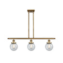 Beacon Island Light shown in the Brushed Brass finish with a Seedy shade