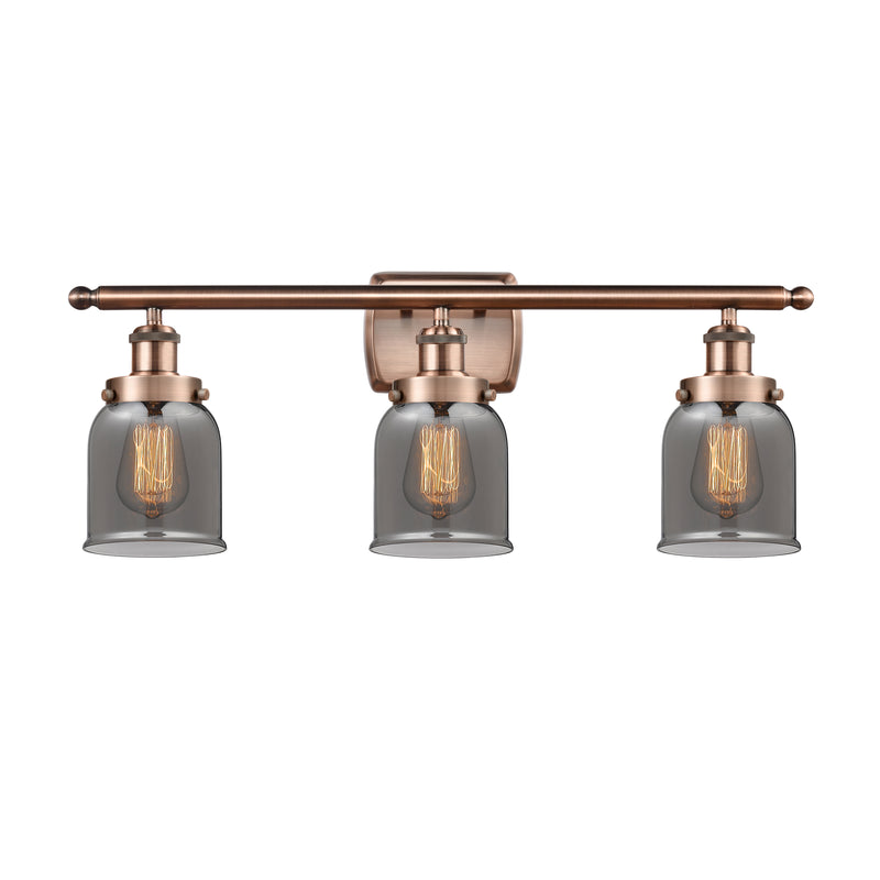 Bell Bath Vanity Light shown in the Antique Copper finish with a Plated Smoke shade