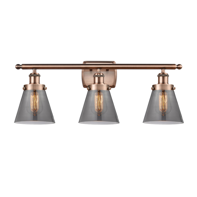 Cone Bath Vanity Light shown in the Antique Copper finish with a Plated Smoke shade