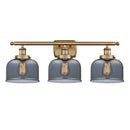 Bell Bath Vanity Light shown in the Brushed Brass finish with a Plated Smoke shade