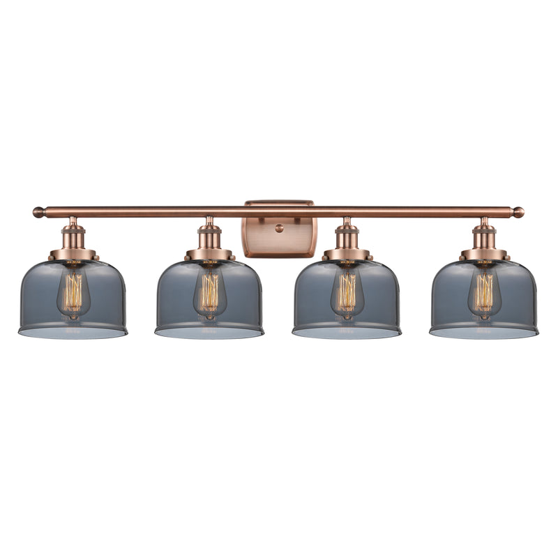 Bell Bath Vanity Light shown in the Antique Copper finish with a Plated Smoke shade