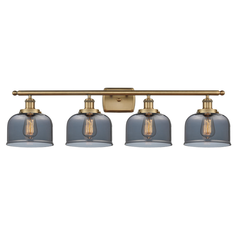 Bell Bath Vanity Light shown in the Brushed Brass finish with a Plated Smoke shade